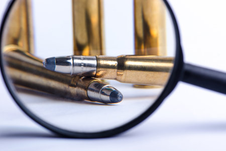 Ammunition on a white background. View through a magnifier. Isolated. Close up. Weapons. Bulletsの写真素材