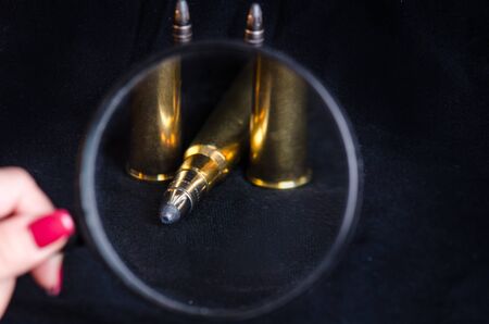 Ammunition on a white background. View through a magnifier. Isolated. Close up. Weapons. Bulletsの写真素材