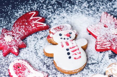 Christmas background decoration. Cinnamon, cookies shape such as heart and star. Flour and spices for a christmas baking on a dark background.の写真素材