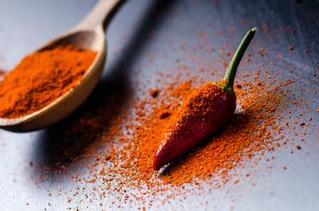 Red chilly peppers, spicy on a wooden spoon. Chilly on a wooden spoon. Vegetable. Concept of hot food.の写真素材