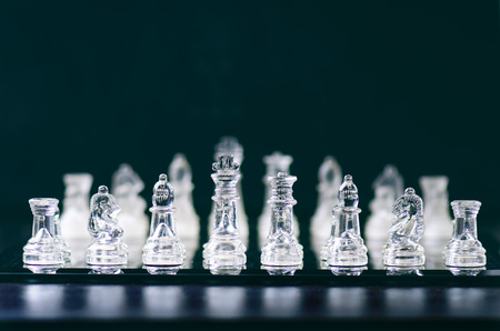 Chess business concept of victory. Chess figures in a reflection of chessboard. Game. Competition and intelligence concept.の写真素材