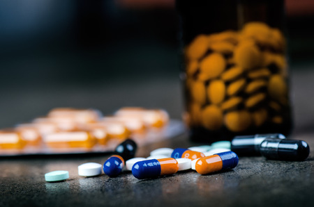 Medicines, supplements in a glass bottle. Pills spilling out from glass bottle. MedicineÂ´s...