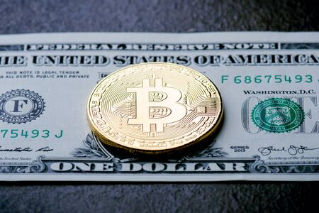 Golden bitcoin coins on a paper dollars money and dark background with sun. Virtual currency. Crypto currency. New virtual money Dollars money. Lens flareの写真素材
