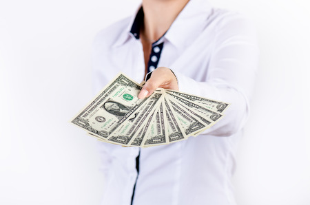 Businesswoman holding dollar banknotes isolated on a white background.Money in women's hands. American currency. One dollar banknotes in a wallet.の写真素材