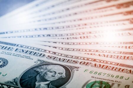 One dollar banknotes on a black table with credit cards. Cash money american dollars. Vintage background. Lens flare. American currency. Internet bankingの写真素材
