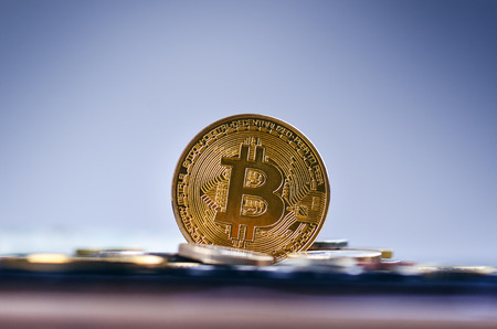 Golden bitcoin coins on a dark background with euro coins. Virtual currency. Crypto currency. New virtual money. Lens flareの写真素材