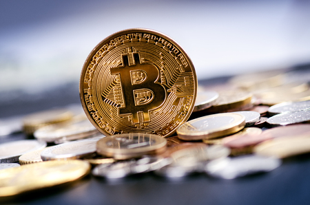 Golden bitcoin coins on a dark background with euro coins. Virtual currency. Crypto currency. New...