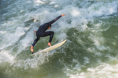 MUNICH - GERMANY, June 2. 2013. Surfer training on the Eisbach in the English Garden in Munichのeditorial素材