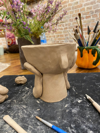 Working table of a ceramist. Clay workshop. The process of creating pottery. The master ceramist works in her studioの写真素材