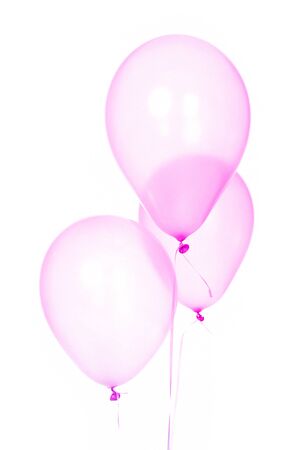 Three fun and cute pink balloons for children's party celebrationの写真素材
