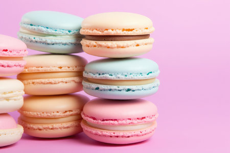 Colorful macaroons on a pink background with copy space.の素材