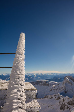 Frozen stair railing in blue skyの写真素材