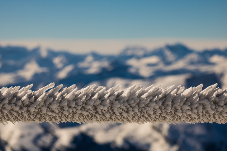 frozen stair railing with mountain backgroundの写真素材