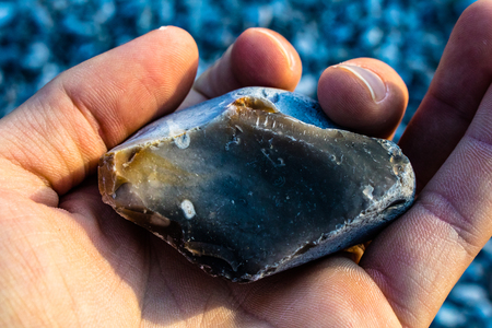 brocken flint in hand holdingの写真素材