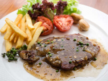 Pepper steak with vegatables and french fries