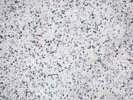 Mosaic of mix pebbles on white wall backgroundの写真素材
