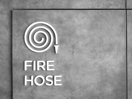 Fire hose sign on concrete wall.の写真素材