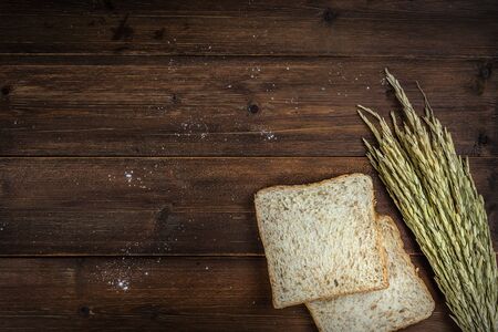 Top view of whole wheat bread on wooden background with copyspaceの写真素材
