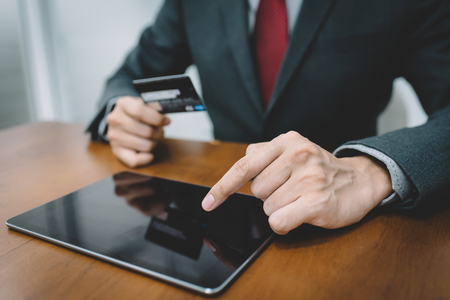 Businessman hand using tablet and credit card. Fintech concept.の写真素材
