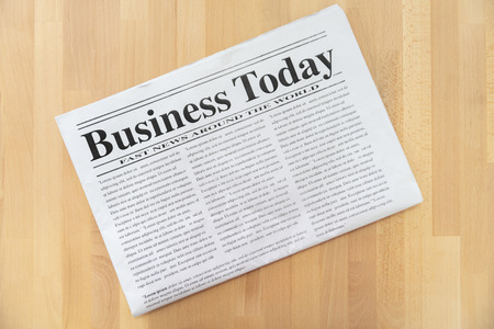 Top view of business newspaper on wooden backgroundの写真素材