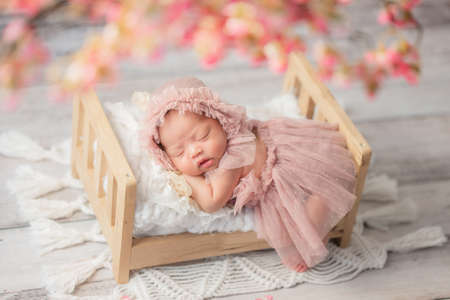 Asian baby infant girl crying and screaming lying on bedの写真素材