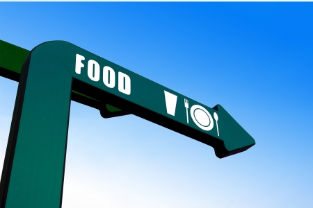 Food sign on green arrow showing directionの写真素材
