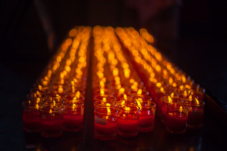 Church candles in red transparent chandeliersの写真素材