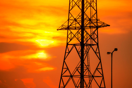 High voltage towers aganist the sunset background.の写真素材