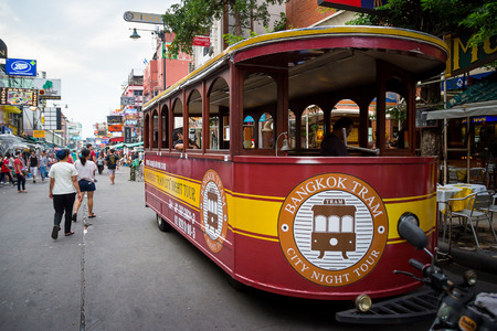 BANGKOK - OCTOBER 19: Bangkok tram for tourism running around Khao San Road in the evening. On rainy dark day. on October 19, 2014 in Bangkok, Thailand.のeditorial素材