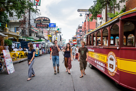 BANGKOK - OCTOBER 19: Bangkok tram for tourism running around Khao San Road in the evening. On rainy dark day. on October 19, 2014 in Bangkok, Thailand.のeditorial素材