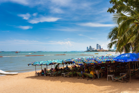 PATTAYA THAILAND  MAY 2 : Colorful umbrella on the beach and tourists playing and relaxing at Beach....