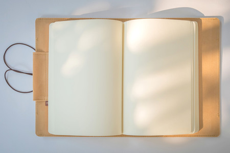 Blank Notebook on a White Paper Backgroundの写真素材