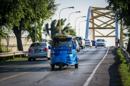 AYUTTHAYA, THAILAND - 6 DEC 2015: Tuk-Tuk driving on the road. It's a popular transportation for...