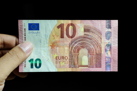 Male hand holding euro money banknotesの写真素材