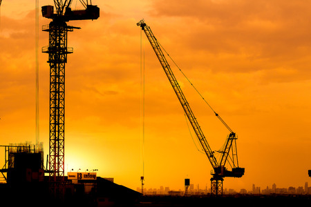 construction cranes and building silhouettesの写真素材