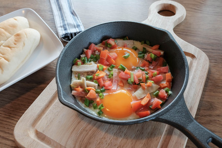 Fried eggs in pan with pork and all vegetable on wood table.It's Vietnamese style and popular in south east asia.の写真素材