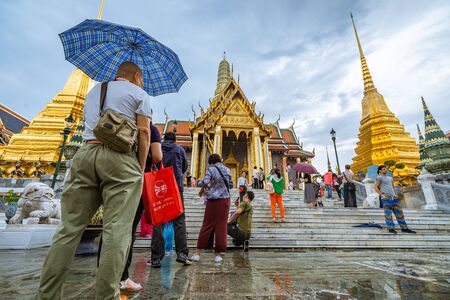 Bangkok, Thailand - April 17: Tourist in Wat Phra Kaew Grand Palace Bangkok on rainy day. on April 17, 2018 in Bangkok, Thailand.のeditorial素材
