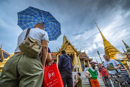 Bangkok, Thailand - April 17: Tourist in Wat Phra Kaew Grand Palace Bangkok on rainy day. on April 17, 2018 in Bangkok, Thailand.のeditorial素材