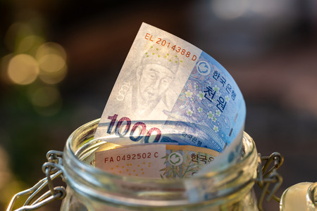 South Korea banknotes in glass jar.