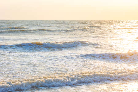 Beautiful sea waves in the morning sunrise.