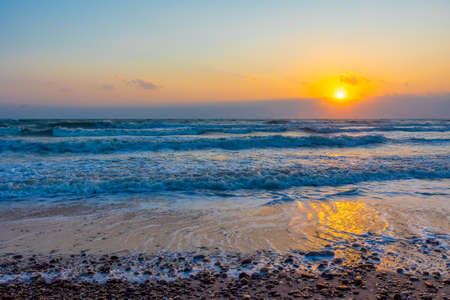 Beautiful sea waves in the morning sunrise.の写真素材