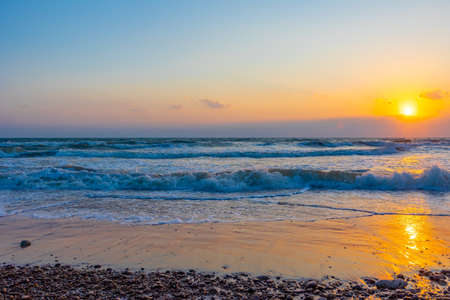 Beautiful sea waves in the morning sunrise.の写真素材
