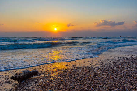 Beautiful sea waves in the morning sunrise.の写真素材