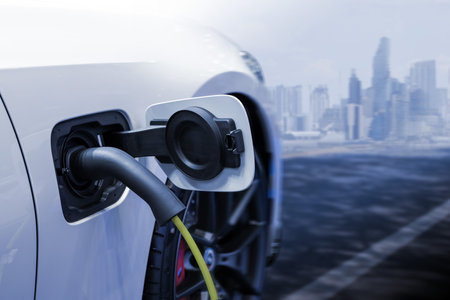 Power cable pump plug in charging power to electric vehicle EV car.の写真素材