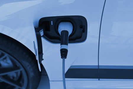 Power cable pump plug in charging power to electric vehicle EV car.の写真素材