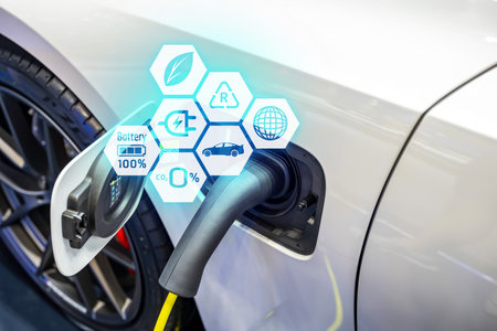 Power cable pump plug in charging power to electric vehicle EV car.の写真素材