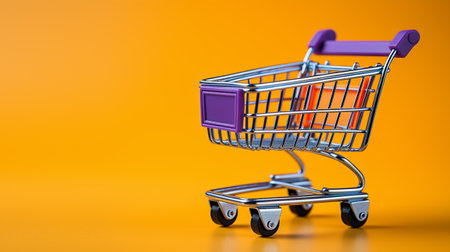 Shopping cart isolated on orange background with copy space for your textの素材
