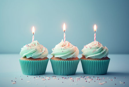Cupcakes with birthday candles on blue background. Toned.の素材