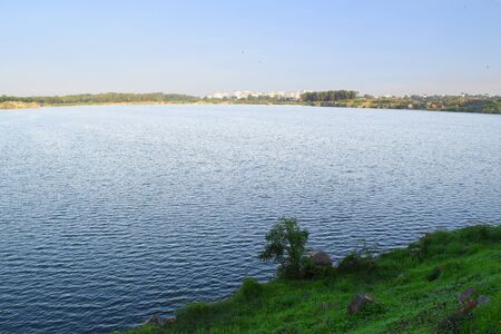 rocky lake with some stones and grass in the bank near Ho Chi Minh city, vietnamの写真素材