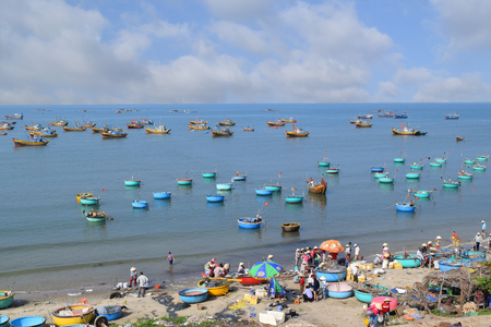 traditional asian fishing boat and village in sea vietnamのeditorial素材
